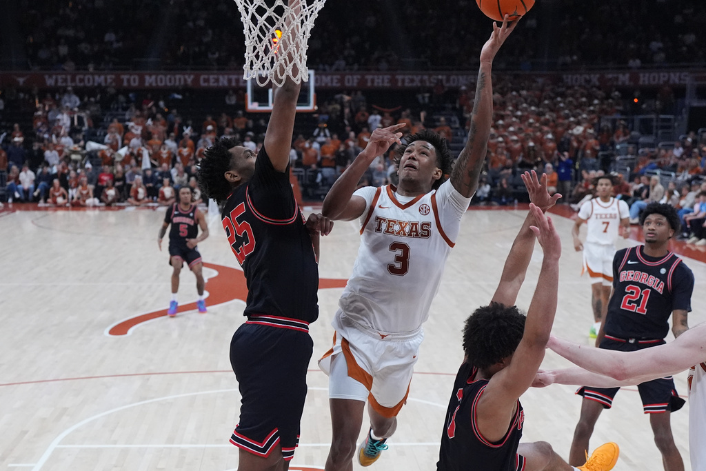Texas guard Dailyn Swain (3) drives to the basket against Georgia forward Justin Abson (25) during the second half of an NCAA college basketball game in Austin, Texas, Saturday, Jan. 24, 2026. (AP Photo/Eric Gay)