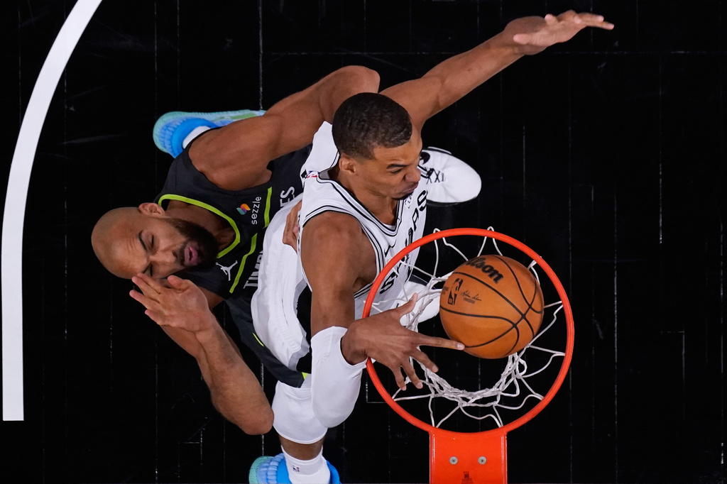 San Antonio Spurs forward Victor Wembanyama (1) scores over Minnesota Timberwolves center Rudy Gobert (27) during the first half in Game 2 of a second-round NBA playoffs basketball series in San Antonio, Wednesday, May 6, 2026. (AP Photo/Eric Gay)