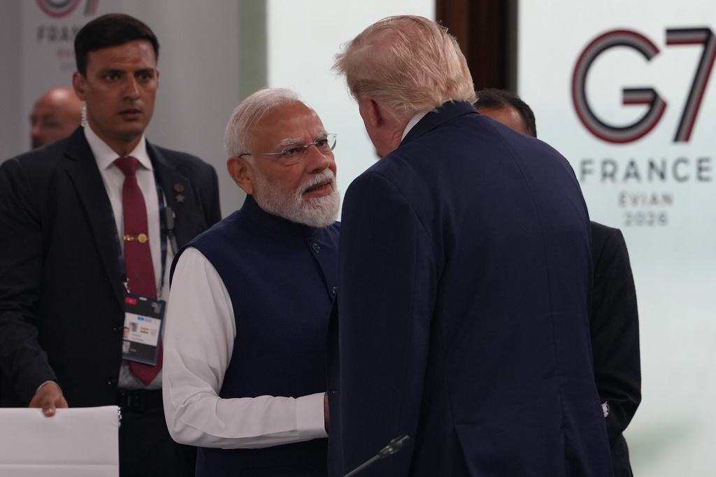 India's Prime Minister Narenda Modi shakes hands with U.S. President Donald Trump before the plenary session at the G7 summit, Tuesday, June 16, 2026, in Evian-les-Bains, France. (AP Photo/Julia Demaree Nikhinson)