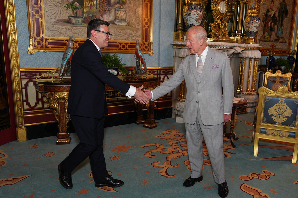 Britain's King Charles III welcomes Andy Burnham, left, during an audience at Buckingham Palace, London, where he invited the leader of the Labour Party to become Prime Minister and form a new government, Monday July 20, 2026. (Aaron Chown/Pool Photo via AP)