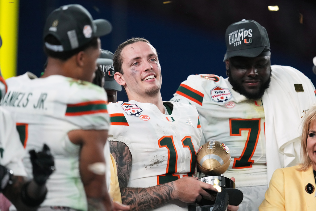 Miami quarterback Carson Beck (11) holds the offensive player of the game trophy after winning the Fiesta Bowl NCAA college football playoff semifinal game against Mississippi, Thursday, Jan. 8, 2026, in Glendale, Ariz. (AP Photo/Ross D. Franklin)