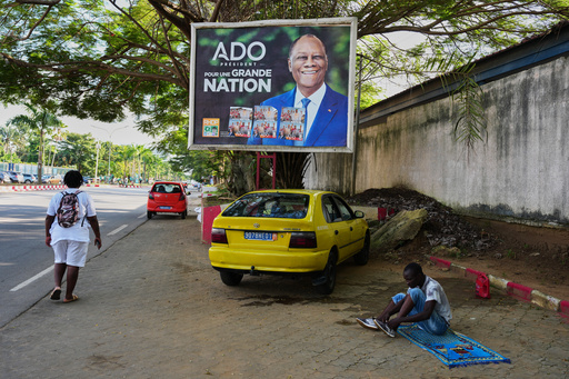 A man sits under a campaign billboard of President Alassane Ouattara in Abidjan, Ivory Coast, Tuesday, Oct. 22, 2025. (AP Photo/Misper Apawu) A man sits under a campaign billboard of President Alassane Ouattara in Abidjan, Ivory Coast, Tuesday, Oct. 22, 2025. (AP Photo/Misper Apawu)