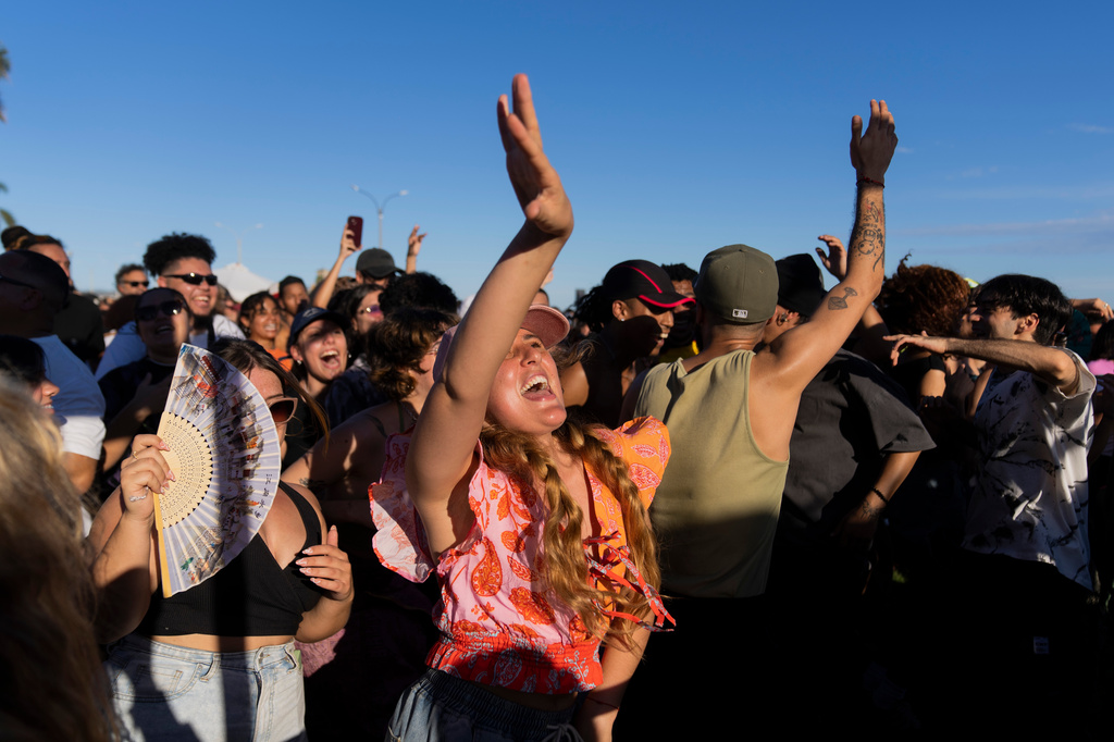 Spectators dance as musicians perform during the Rueda de Candombe at Plaza Espana in Montevideo, Uruguay, Sunday, April 19, 2026. (AP Photo/Matilde Campodonico)