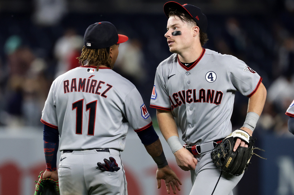 Cleveland Guardians second baseman Travis Bazzana celebrates with third baseman José Ramírez (11) after defeating the New York Yankees in a baseball game Tuesday, June 2, 2026, in New York. (AP Photo/Adam Hunger)