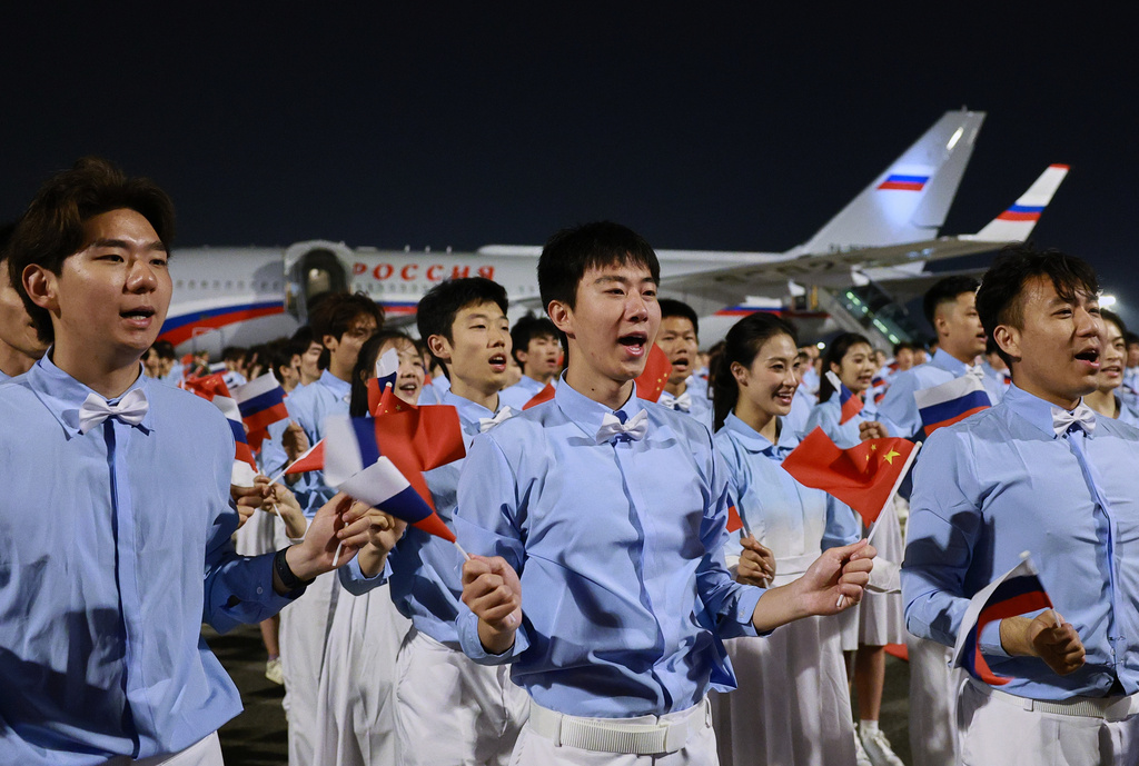 Chinese youth greet Russian President Vladimir Putin as he arrives in Beijing, Tuesday, May 19, 2026, for a two day visit to meet President Xi Jinping. (Vladimir Smirnov, Sputnik, Kremlin Pool Photo via AP)