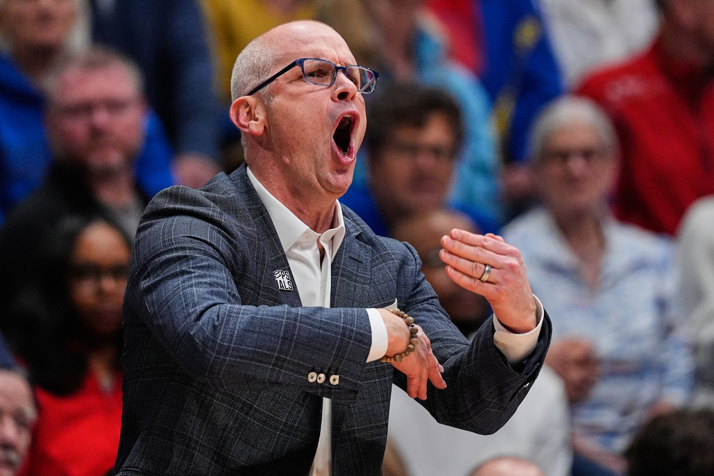 UConn head coach Dan Hurley motions to his players during the first half of an NCAA college basketball game against Kansas, Tuesday, Dec. 2, 2025, in Lawrence, Kan. (AP Photo/Charlie Riedel)