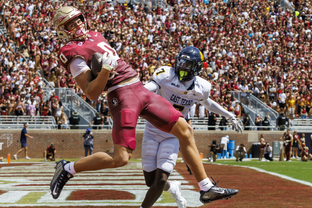 Florida State wide receiver Duce Robinson (0) makes a touchdown catch in front of East Texas A&M defensive back Javon Gillespie (7) during the first half of an NCAA college football game, Saturday, Sept. 6, 2025, in Tallahassee, Fla. (AP Photo/Colin Hackley)