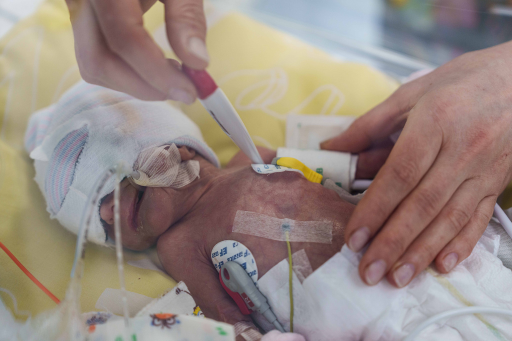 A nurse checks the temperature of a premature baby inside a temperature-controlled incubator at the regional perinatal center of Zaporizhzhia, Ukraine, Wednesday, May 6, 2026. (AP Photo/Evgeniy Maloletka)
