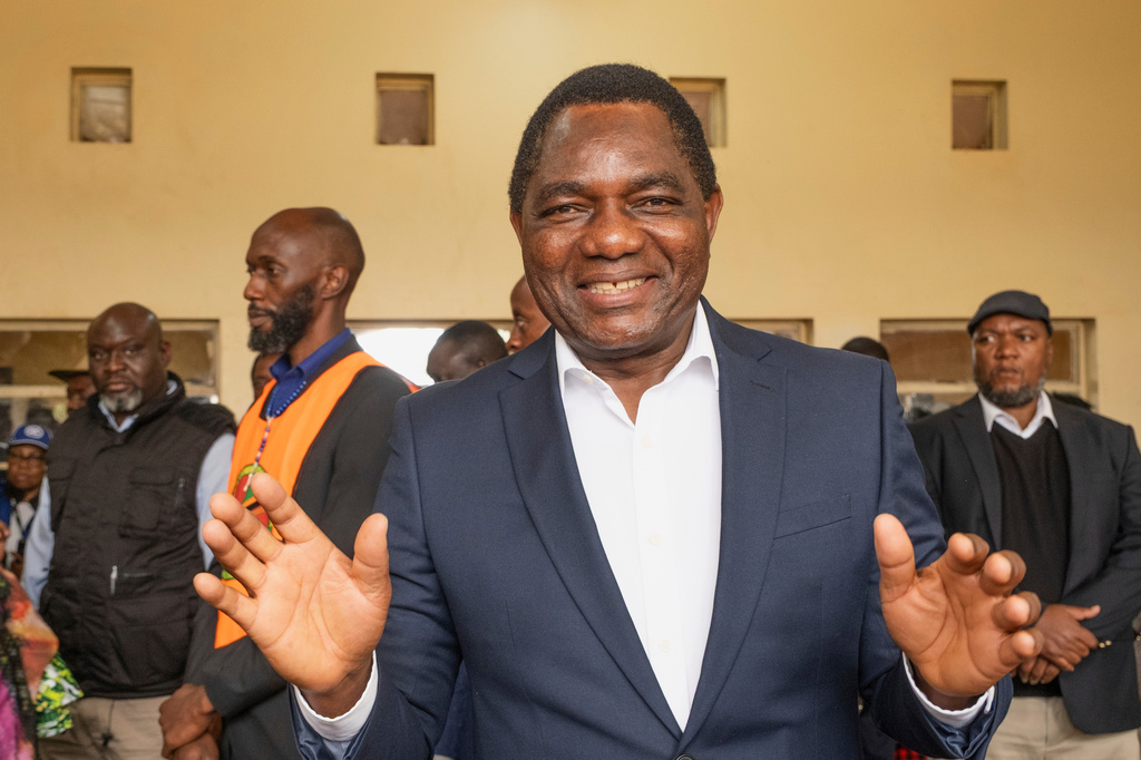 Zambia's President Hakainde Hichilema shares a light moment with journalists after casting his vote at a polling station in Lusaka, Zambia, Thursday, Aug. 13, 2026. (AP Photo/Anita Reed)