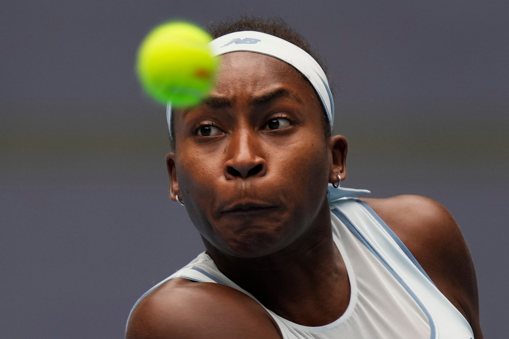 Coco Gauff of the United States returns a shot from compatriot Amanda Anisimova in a women's singles semifinal match of the China Open tennis tournament in Beijing, China, Saturday, Oct. 4, 2025.(AP Photo/Ng Han Guan)