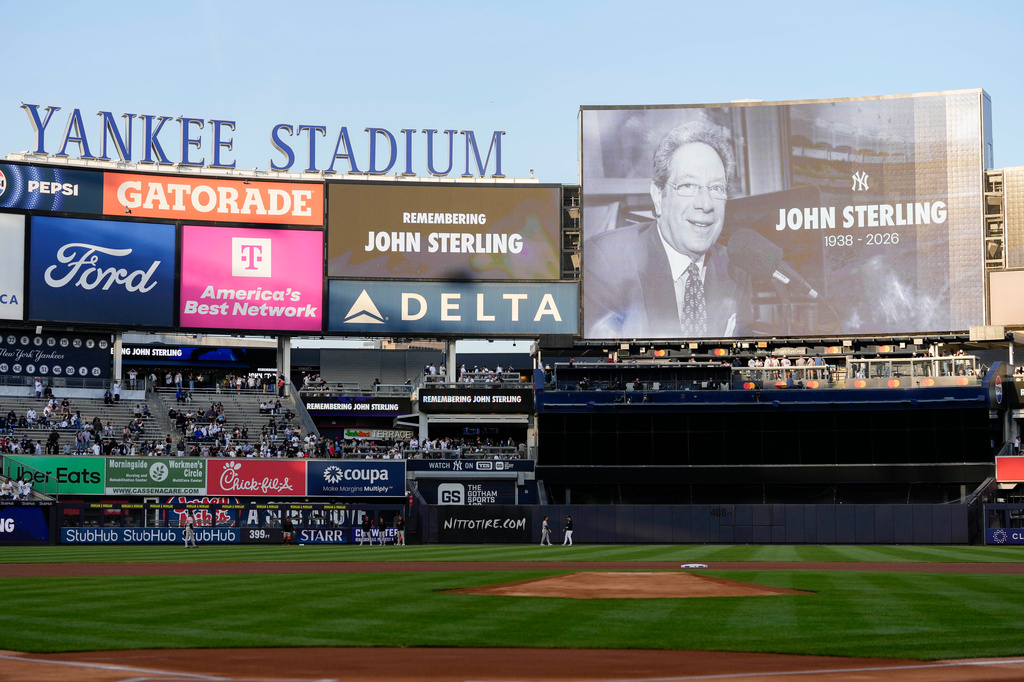 A scoreboard displays late former New York Yankees broadcaster John Sterling during a tribute to Sterling ahead of a baseball game between the New York Yankees and the Baltimore Orioles, Monday, May 4, 2026, in New York. (AP Photo/Yuki Iwamura)