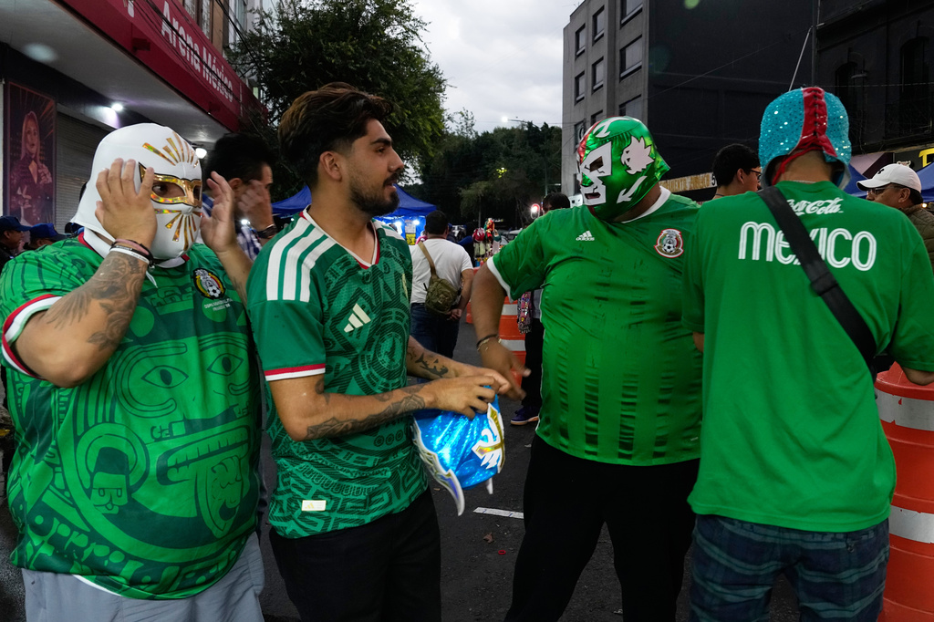 Mexicans wearing Lucha masks prepare to enter Arena Mexico in Mexico City, Friday, June 26, 2026. (AP Photo/Marco Ugarte)