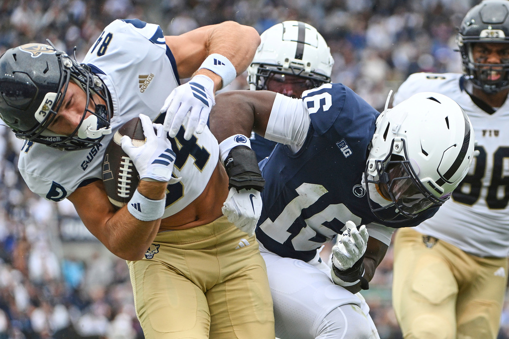 Penn State safety King Mack (16) tackles Florida International wide receiver Maguire Anderson (84) during the first quarter of an NCAA college football game, Saturday, Sept. 6, 2025, in State College, Pa. (AP Photo/Barry Reeger)