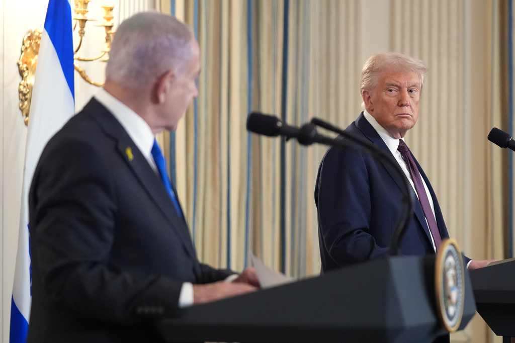 FILE - President Donald Trump, right, listens during a news conference with Israeli Prime Minister Benjamin Netanyahu in the State Dining Room of the White House, Sept. 29, 2025, in Washington. (AP Photo/Evan Vucci, File)