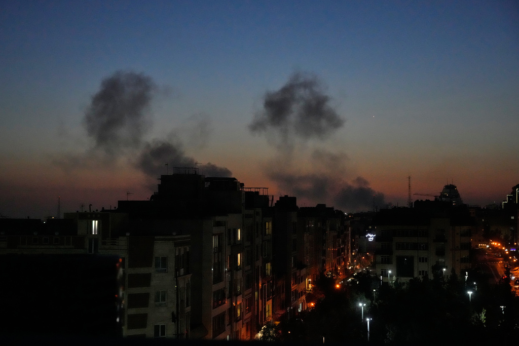 Plumes of smoke rise as strikes hit the city during the U.S.–Israeli military campaign in Tehran, Iran, Friday night, March 6, 2026. (AP Photo/Vahid Salemi)