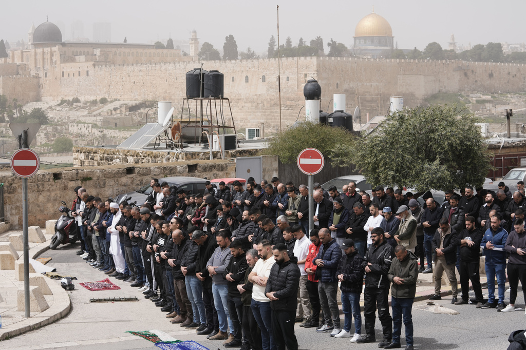 Palestinian Muslims attend Friday prayers outside Jerusalem's Old City due to restrictions linked to the Iran war, April 3, 2026. (AP Photo/Mahmoud Illean)