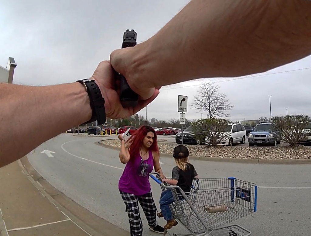This police body cam still image provided by the Omaha Police Department shows an Omaha police officer responding to a woman they say kidnapped a young boy and slashed him across the face before killing her in Omaha, Neb. on Tuesday April 14, 2026. (Omaha Police Department via AP)