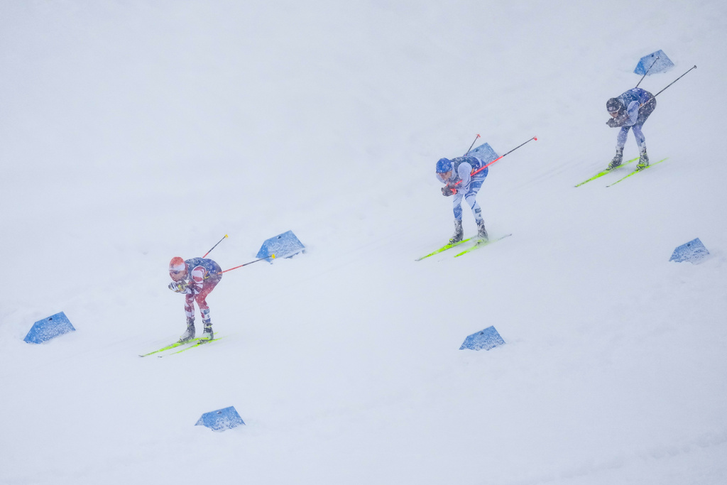 Johannes Lamparter, of Austria, from left, Eero Hirvonen, of Finland, and Ryota Yamamoto, of Japan, compete in the nordic combined team sprint at the 2026 Winter Olympics, in Tesero, Italy, Thursday, Feb. 19, 2026. (AP Photo/Evgeniy Maloletka)