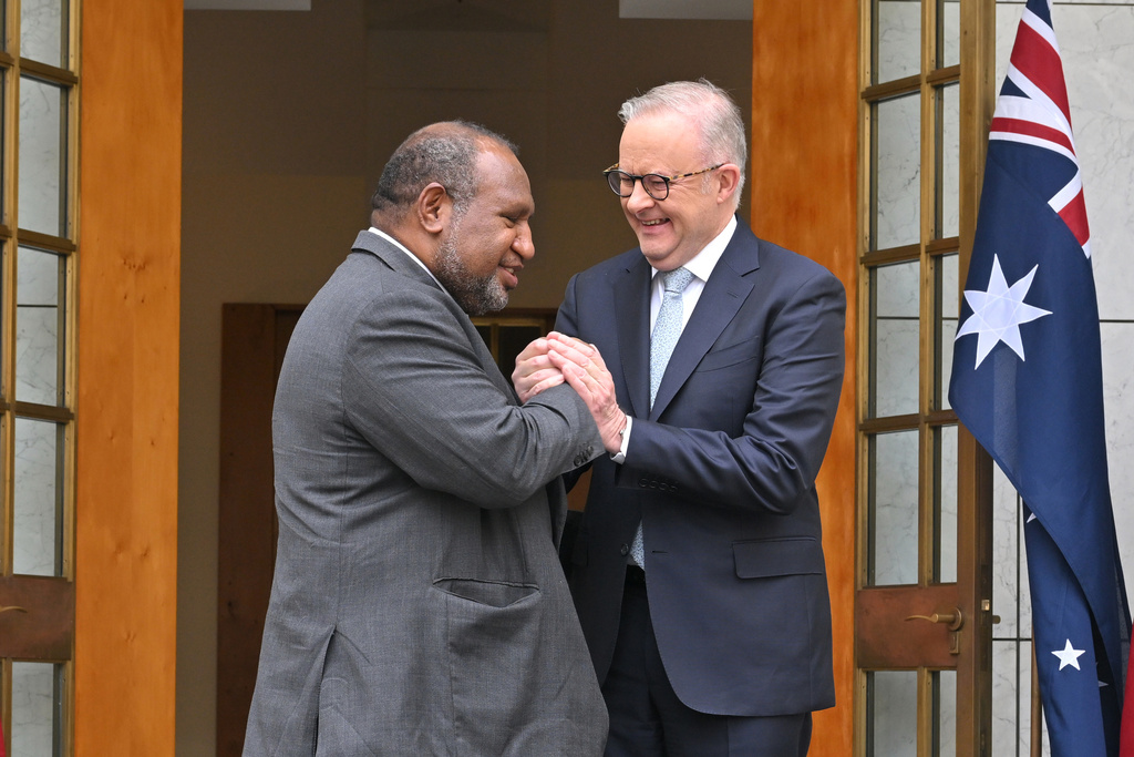 Australia's Prime Minister Anthony Albanese, right, shakes hands with Papua New Guinea's Prime Minister James Marape before signing a defense treaty at Parliament House in Canberra, Australia, Monday, Oct. 6, 2025. (Mick Tsikas/AAP Image via AP)