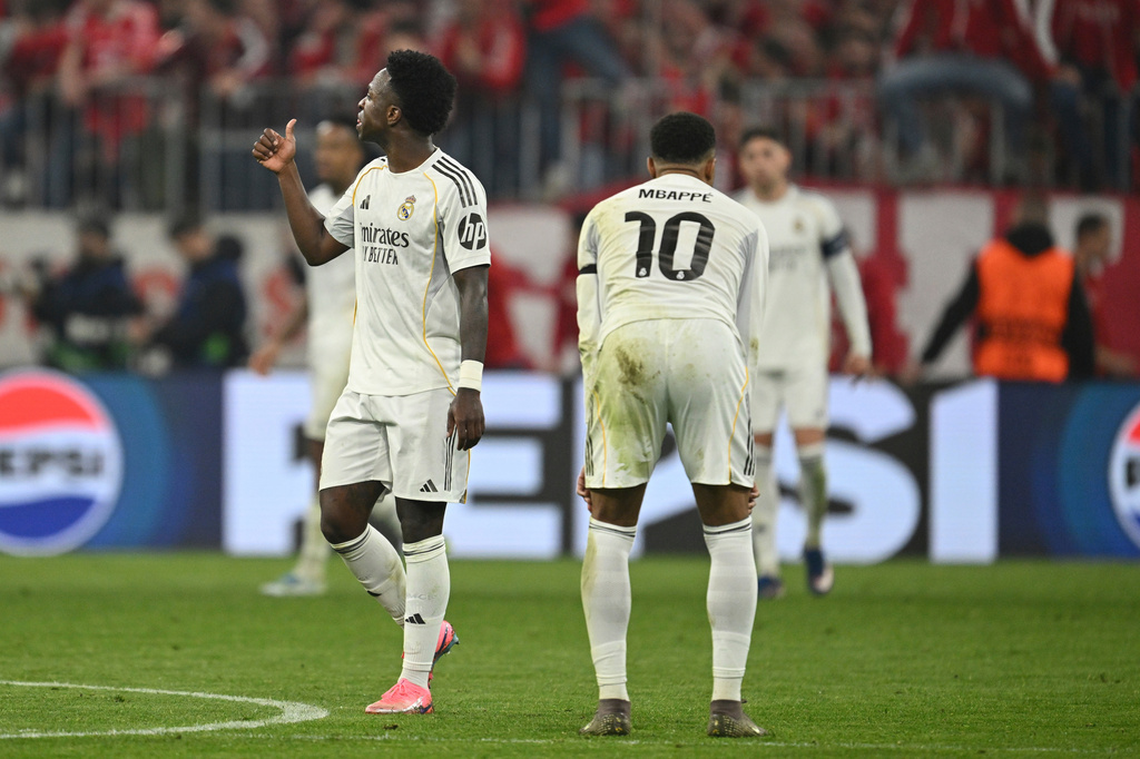 Real Madrid's Kylian Mbappe and his teammate Vinicius Junior react at the end of the Champions League quarterfinal second leg soccer match between Bayern Munich and Real Madrid in Munich, Germany, Wednesday, April 15, 2026. (AP Photo/Lennart Preiss)