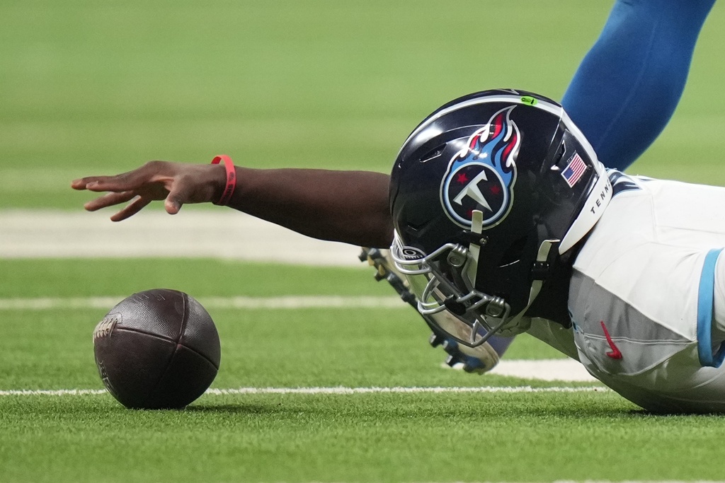 Tennessee Titans quarterback Cam Ward recovers the football after being tackled during the second half an NFL football game against the Indianapolis Colts, Sunday, Oct. 26, 2025, in Indianapolis. (AP Photo/AJ Mast)