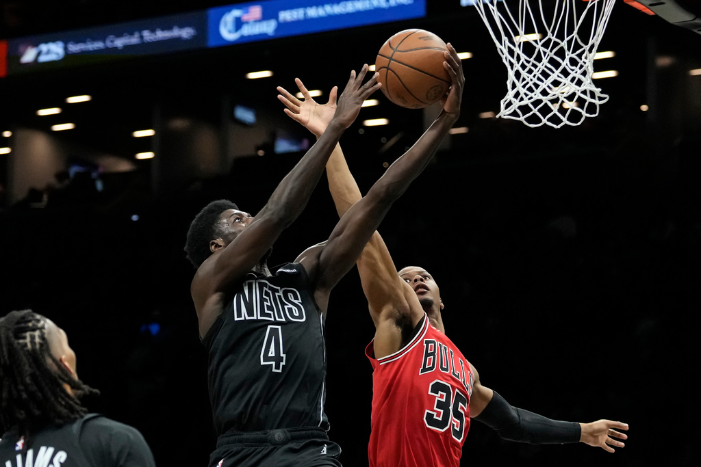 Brooklyn Nets guard Drake Powell (4) is blocked by Chicago Bulls forward Isaac Okoro (35) during the first half of an NBA basketball game, Monday, Feb. 9, 2026, in New York. (AP Photo/Yuki Iwamura)