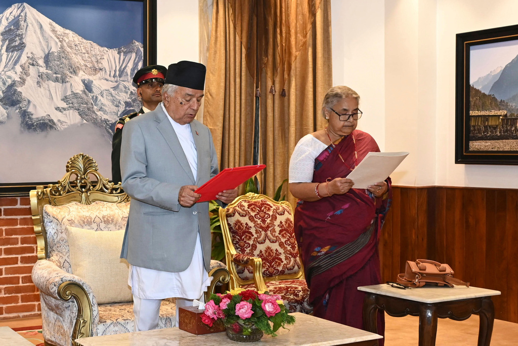 In this photo provided by the Nepalese President House, former Supreme Court Chief Justice Sushila Karki, right, is administered the oath of office by Nepalese President Ram Chandra Poudel, center, in Kathmandu, Nepal, Friday, Sept. 12, 2025, following protests that collapsed the previous administration. (Nepalese President House via AP)