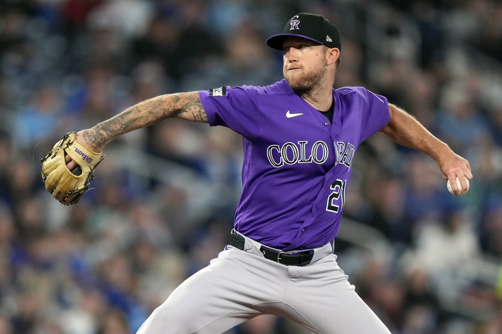 Colorado Rockies pitcher Kyle Freeland (21) throws during the first inning of a baseball game against the Toronto Blue Jays, Wednesday, April 1, 2026, in Toronto. (Nathan Denette/The Canadian Press via AP)
