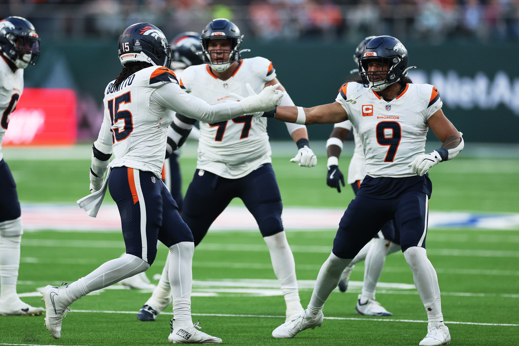 From left; Denver Broncos linebacker Nik Bonitto, defensive end Zach Allen and safety Talanoa Hufanga celebrate after sacking New York Jets quarterback Justin Fields in the second half of an NFL football game Sunday, Oct. 12, 2025, in London. (AP Photo/Ian Walton)