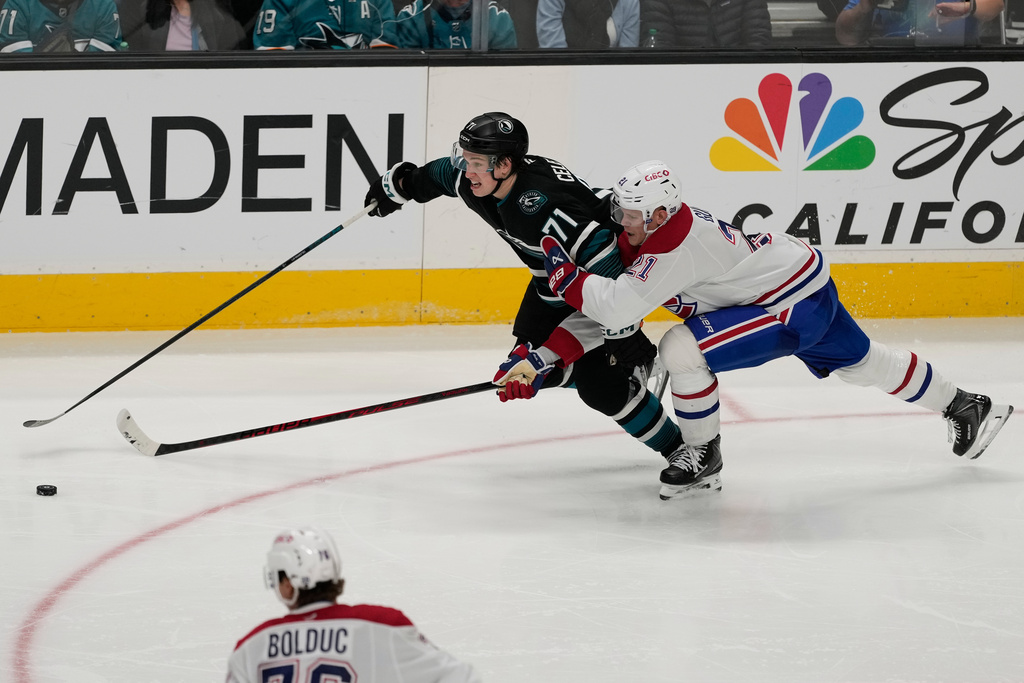 San Jose Sharks center Macklin Celebrini (71) skates with the puck against Montréal Canadiens defenseman Kaiden Guhle (21) during the third period of an NHL hockey game in San Jose, Calif., Tuesday, March 3, 2026. (AP Photo/Jeff Chiu)