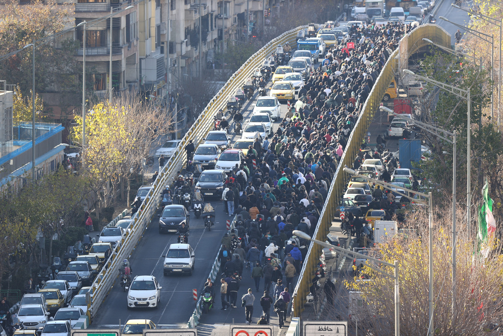 FILE - Protesters march on a bridge in Tehran, Iran, on Dec. 29, 2025. (Fars News Agency via AP, File)