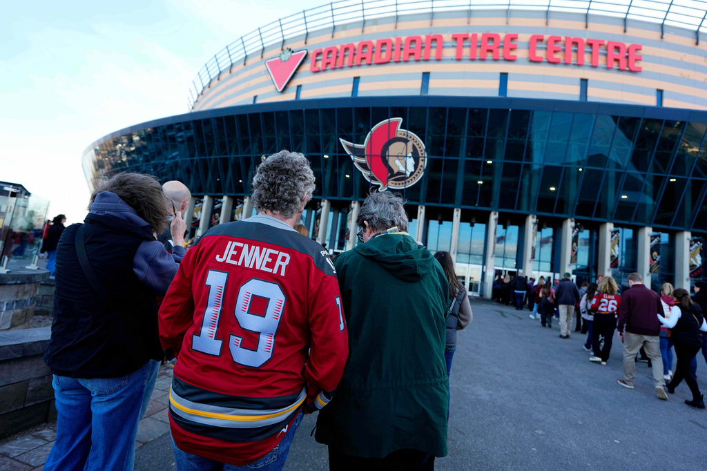 FILE - A fan wearing a jersey with the name of Ottawa Charge captain Brianne Jenner arrives for a PWHL hockey game against the Montreal Victoire at the Canadian Tire Centre, home of the NHL's Ottawa Senators, in Ottawa, Ontario, Friday, April 3, 2026. (Justin Tang/The Canadian Press via AP, File)
