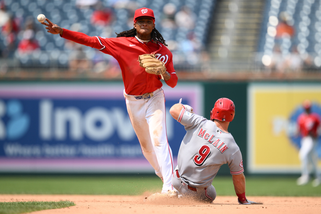 Cincinnati Reds' Matt McLain (9) is out at second base as Washington Nationals shortstop CJ Abrams, top, throws to first base to put out Reds' TJ Friedl for a double play during the eighth inning of a baseball game, Sunday, Aug. 9, 2026, in Washington. (AP Photo/Nick Wass)
