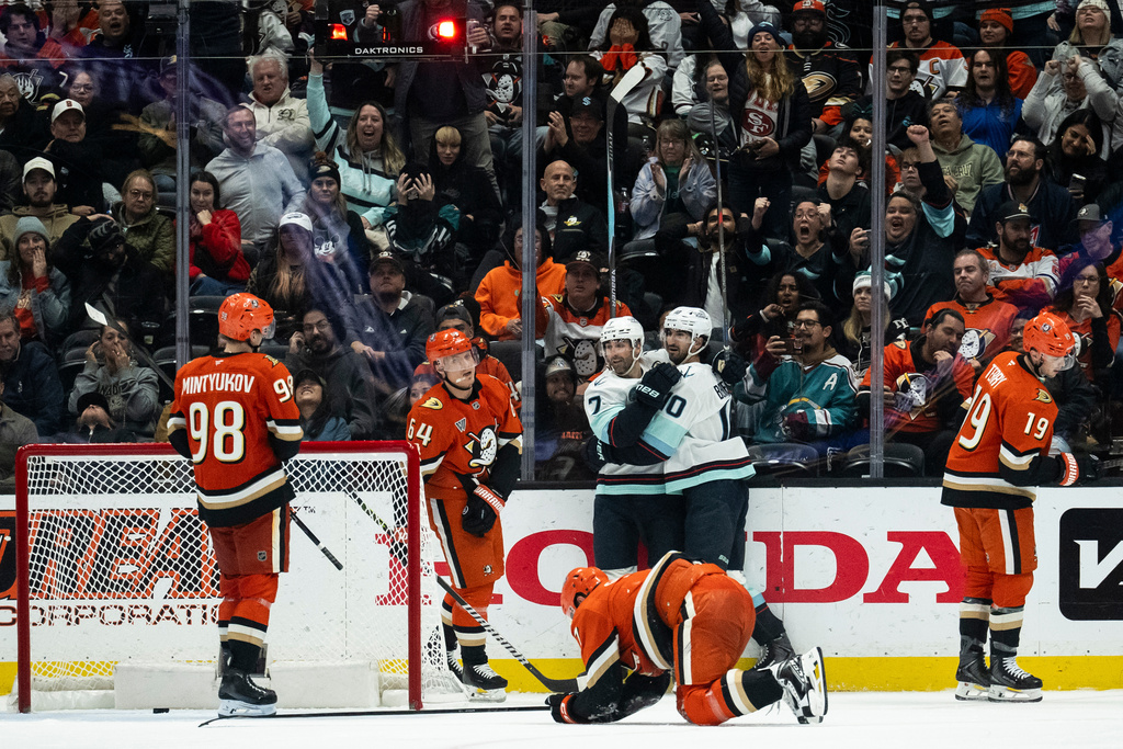 Seattle Kraken right wing Jordan Eberle (7) celebrates his goal with center Matty Beniers (10) during the third period of an NHL hockey game against the Anaheim Ducks, Monday, Dec. 22, 2025, in Anaheim, Calif. (AP Photo/Kyusung Gong)