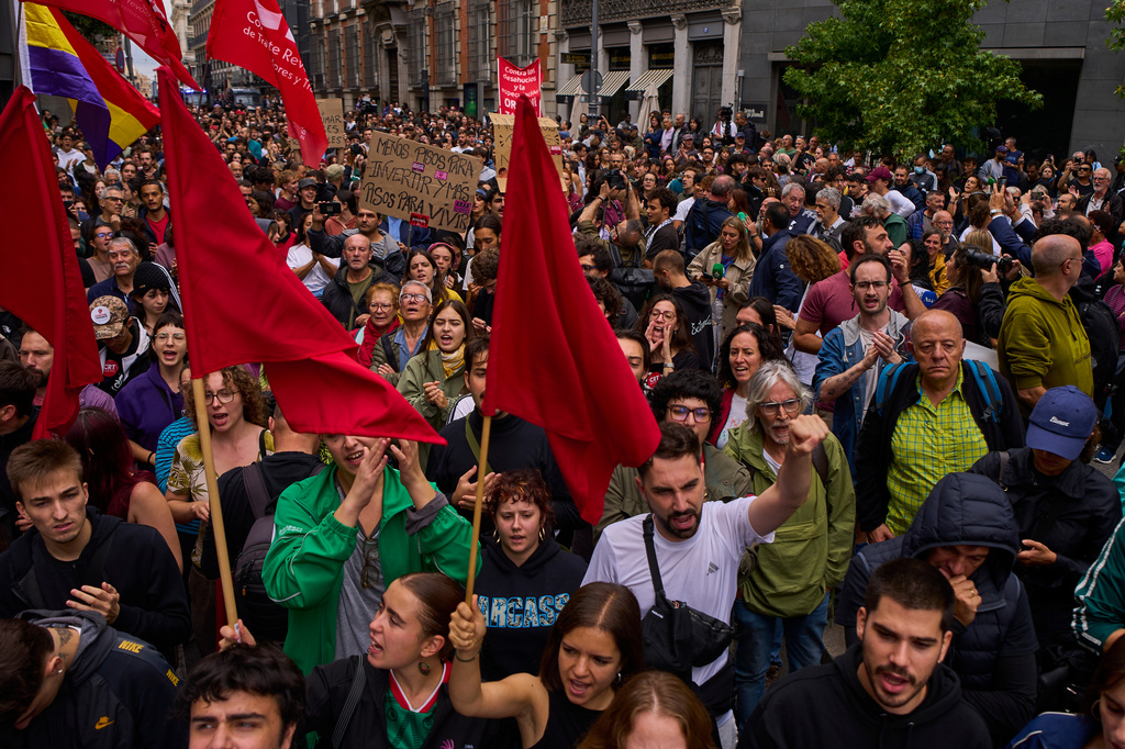 Activists protest near the Spanish Parliament following the eviction of 87-year-old Maricarmen to demand stronger laws to protect renters in Madrid, Spain, Friday, Oct. 2, 2026. (AP Photo/Manu Fernandez)