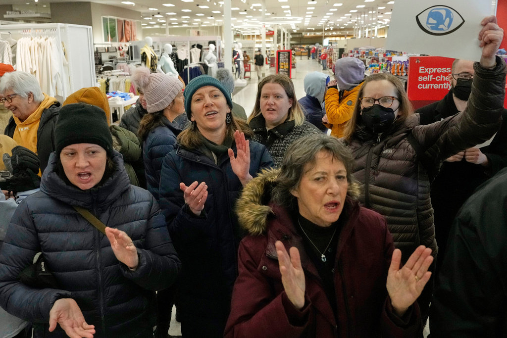 Community members and neighbors of people detained by ICE protest at a Target store, Monday, Jan. 19, 2026, in St. Paul, Minn. (AP Photo/Yuki Iwamura)