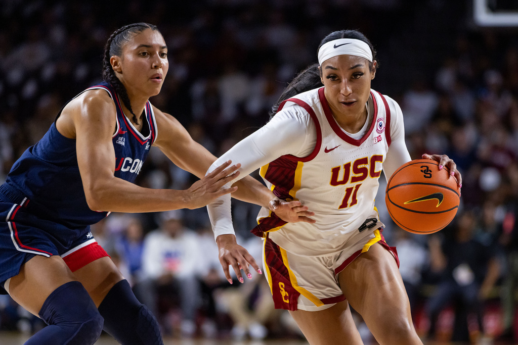 Southern California guard Kennedy Smith (11) drives the ball against UConn guard Azzi Fudd (35) during the first half of an NCAA college basketball game Saturday, Dec. 13, 2025, in Los Angeles. (AP Photo/Ethan Swope)