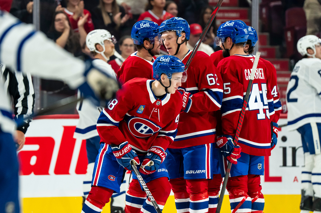 Montreal Canadiens' Lane Hutson (48), front center, celebrates his goal against the Toronto Maple Leafs, with teammates during third period NHL pre-season hockey action, in Montreal, on Saturday, Sept. 19, 2026. (Christopher Katsarov/The Canadian Press via AP)