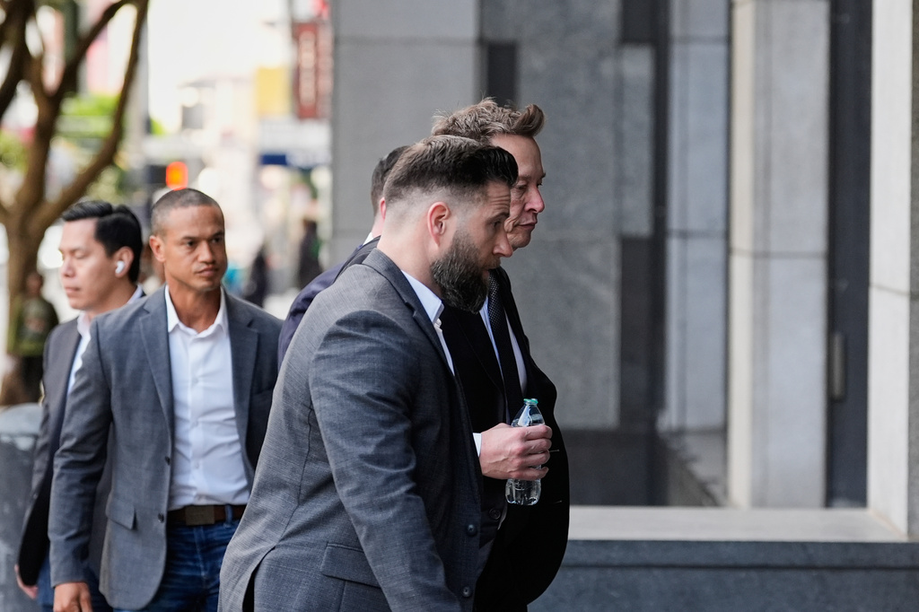 Elon Musk, right, arrives for a Twitter shareholder trial at the U.S. District Court for the Northern District of California in San Francisco, on Wednesday, March 4, 2026. (AP Photo/Godofredo A. Vásquez)