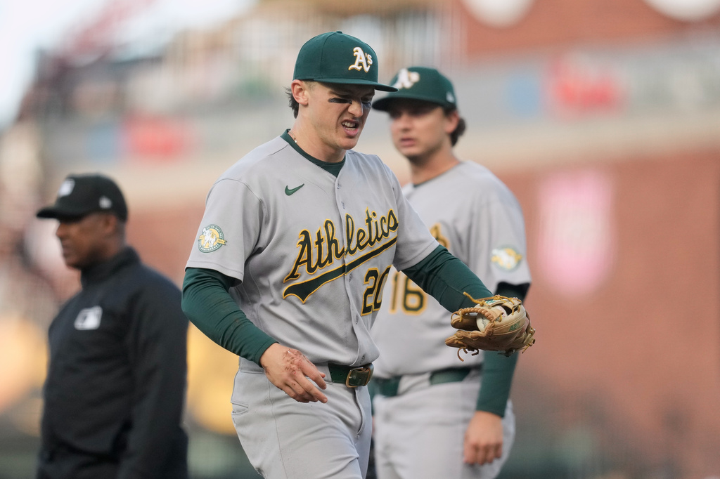 Athletics second baseman Zack Gelof, left, reacts as he walks off the field during the second inning of a baseball game against the San Francisco Giants Tuesday, June 23, 2026, in San Francisco. (AP Photo/Jeff Chiu)