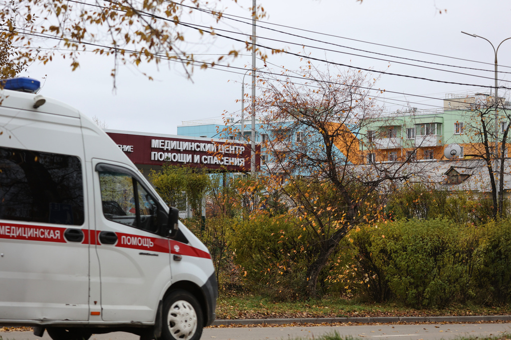 An ambulance drives past the medical center for treating infectious diseases, center, in Shelekhov, outside Irkutsk, Russia, on Thursday, Oct. 8, 2026. (AP Photo)