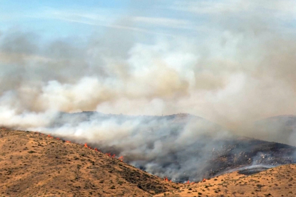 This image taken from video shows active wildfires Saturday, Aug. 22, 2026, in Reno, Nevada. (Tim Walton via AP)