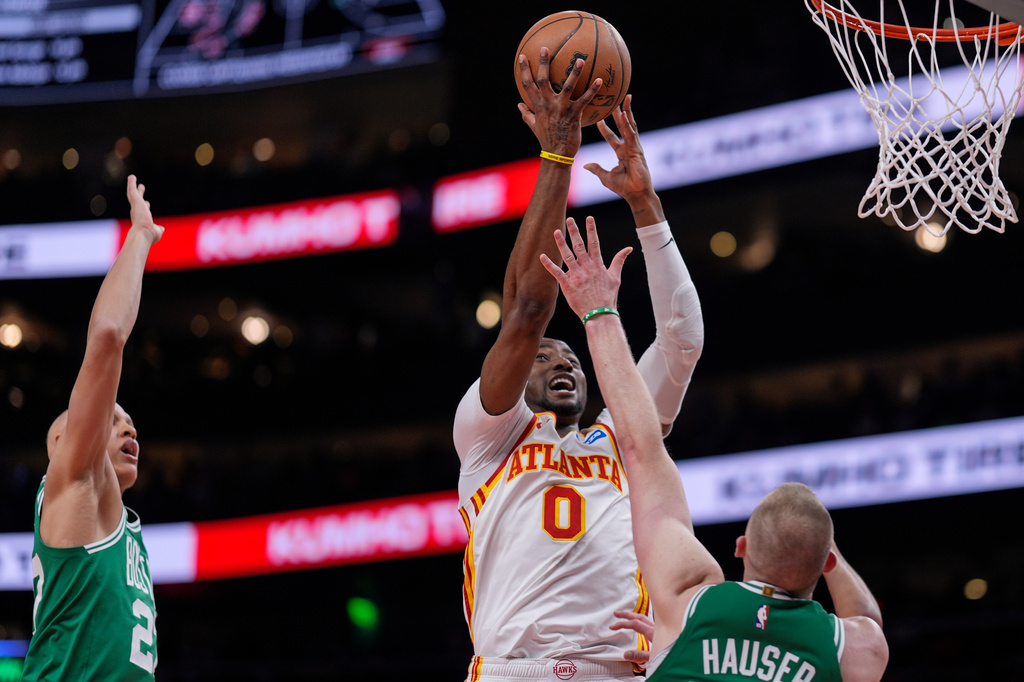 Atlanta Hawks forward Jonathan Kuminga (0) shoots against Boston Celtics forward Sam Hauser (30) in the first half of an NBA basketball game, Monday, March 30, 2026, in Atlanta. (AP Photo/Mike Stewart)