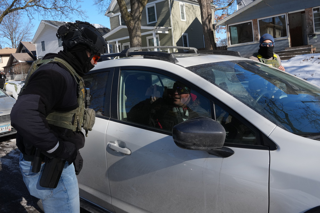 FILE - A federal agent approaches a vehicle on Jan. 29, 2026, in Minneapolis. (AP Photo/Adam Gray, File)