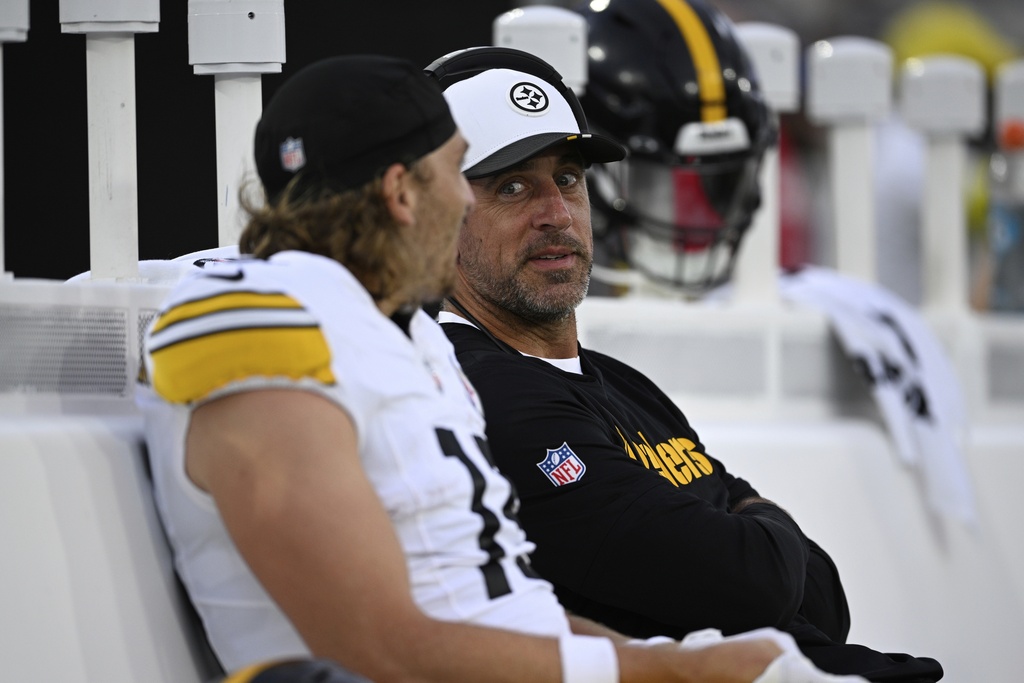 Pittsburgh Steelers quarterback Aaron Rodgers talks with wide receiver Ben Skowronek during the first half of an NFL preseason football game against the Jacksonville Jaguars, Saturday, Aug. 9, 2025, in Jacksonville, Fla. (AP Photo/Phelan M. Ebenhack)
