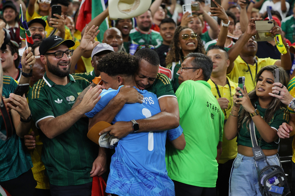 South Africa goalkeeper Ronwen Williams (1) is embraced by supporters after the World Cup Group A soccer match between South Africa and South Korea in Guadalupe, near Monterrey, Mexico, Wednesday, June 24, 2026. (AP Photo/Sofia Yaker)
