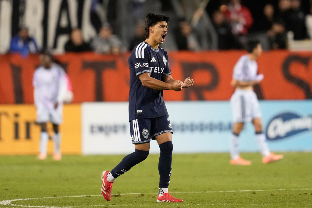 Vancouver Whitecaps defender Mathias Laborda celebrates after teammate Sebastian Berhalter scored against the San Jose Earthquakes during the second half of an MLS soccer match Saturday, May 9, 2026, in San Jose, Calif. (AP Photo/Jeff Chiu)