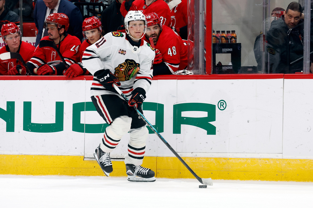 Chicago Blackhawks' Oliver Moore (11) skates with the puck during a shootout in an NHL hockey game against the Carolina Hurricanes in Raleigh, N.C., Thursday, Jan. 22, 2026. (AP Photo/Karl DeBlaker)