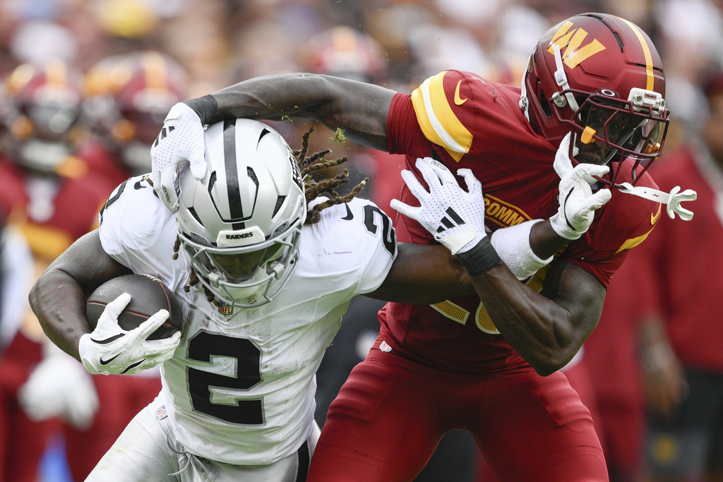 Las Vegas Raiders running back Ashton Jeanty (2) runs against Washington Commanders safety Quan Martin (20) during the first half of NFL football game Sunday, Sept. 21, 2025, in Landover, Md. (AP Photo/Nick Wass)