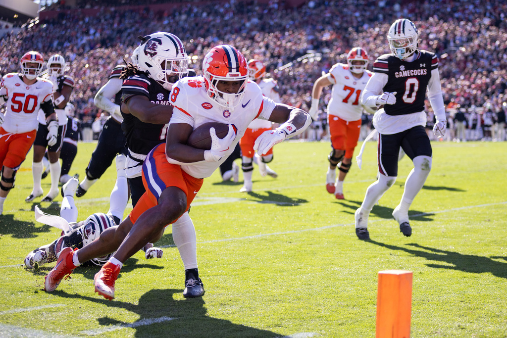 Clemson running back Adam Randall (8) runs in for a touchdown against South Carolina during the first half of an NCAA college football game, Saturday, Nov. 29, 2025, in Columbia, S.C. (AP Photo/Scott Kinser)